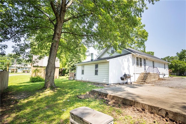 1619 W College St, Independence, MO 64050 - rear view of property featuring a yard and a patio