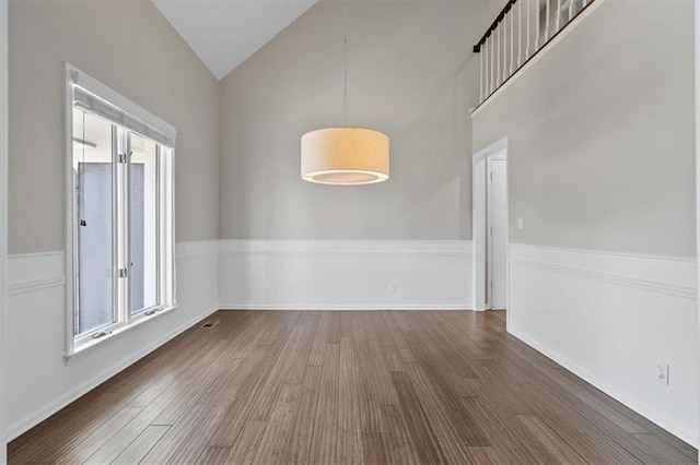 11412 Foster St, Overland Park, KS 66210 - unfurnished dining area featuring healthy amount of natural light, wood finished floors, and high vaulted ceiling