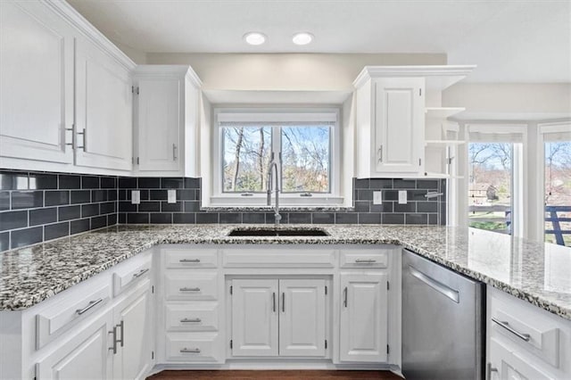 11412 Foster St, Overland Park, KS 66210 - kitchen featuring dishwasher, white cabinetry, open shelves, light stone countertops, and backsplash