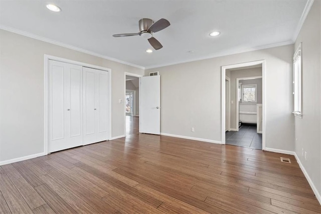11412 Foster St, Overland Park, KS 66210 - unfurnished bedroom featuring wood finished floors, crown molding, recessed lighting, a closet, and a ceiling fan