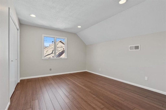 11412 Foster St, Overland Park, KS 66210 - bonus room with hardwood / wood-style floors, lofted ceiling, a textured ceiling, and recessed lighting