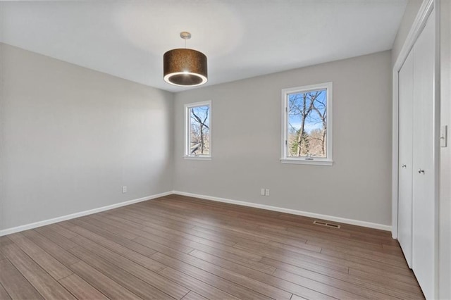 11412 Foster St, Overland Park, KS 66210 - unfurnished bedroom featuring a closet and wood finished floors