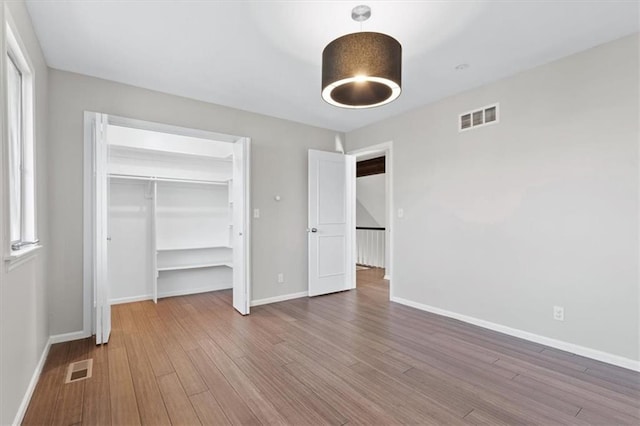 11412 Foster St, Overland Park, KS 66210 - unfurnished bedroom featuring wood finished floors and a closet