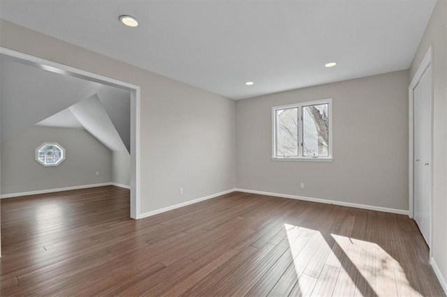11412 Foster St, Overland Park, KS 66210 - unfurnished bedroom featuring multiple windows, dark wood finished floors, and recessed lighting