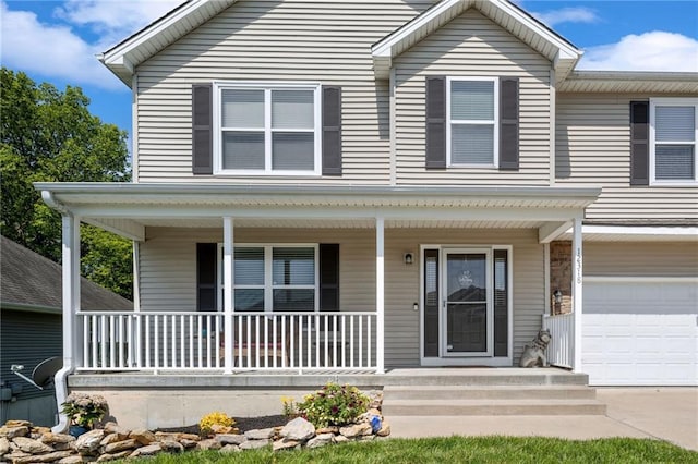 12318 N Wayne Ave, Kansas City, MO 64165 - view of front of house featuring covered porch and a garage