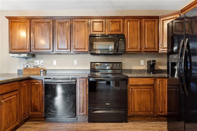 12318 N Wayne Ave, Kansas City, MO 64165 - kitchen featuring black appliances, wood finished floors, dark countertops, and brown cabinets