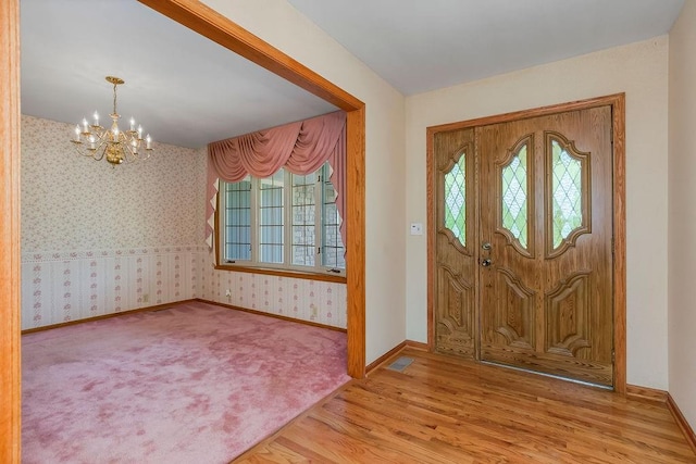 18209 E Moorland St, Pleasant Hill, MO 64080 - foyer entrance with a chandelier, wood finished floors, and wallpapered walls