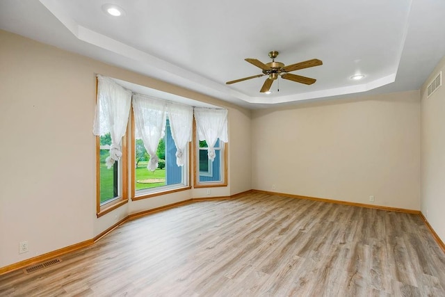 18209 E Moorland St, Pleasant Hill, MO 64080 - empty room featuring a raised ceiling, light wood-style flooring, recessed lighting, and a ceiling fan