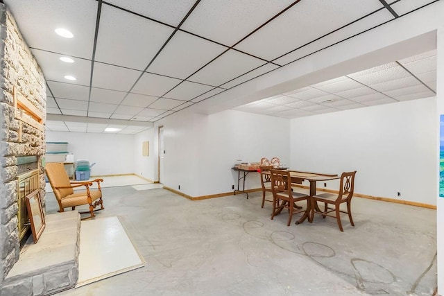18209 E Moorland St, Pleasant Hill, MO 64080 - dining area featuring concrete floors, a large fireplace, and a drop ceiling