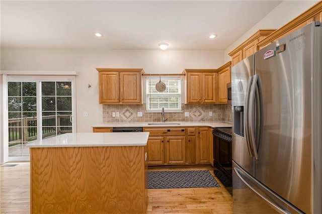 1905 160th St, Basehor, KS 66007 - kitchen with stainless steel fridge with ice dispenser, stove, light wood-type flooring, light countertops, and backsplash