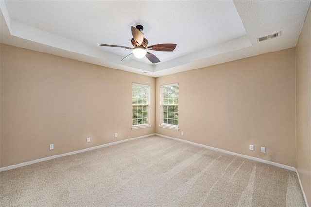 1905 160th St, Basehor, KS 66007 - empty room with a raised ceiling, ceiling fan, and light carpet
