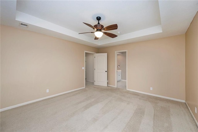 1905 160th St, Basehor, KS 66007 - spare room with a tray ceiling, ceiling fan, and light colored carpet