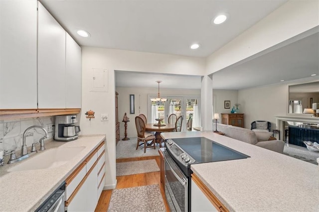 5137 W 75th St, Prairie Village, KS 66208 - kitchen featuring appliances with stainless steel finishes, light wood-style flooring, white cabinetry, and recessed lighting