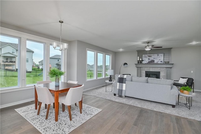 6102 Lewis Dr, Shawnee, KS 66226 - dining space with healthy amount of natural light, a ceiling fan, a fireplace, and wood finished floors