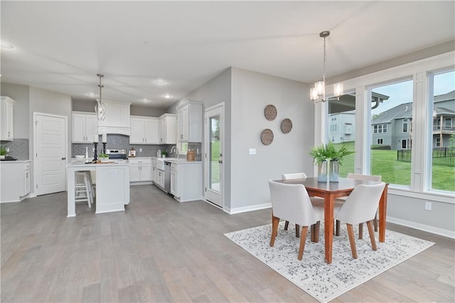 6102 Lewis Dr, Shawnee, KS 66226 - dining space with light wood-style floors, a chandelier, and recessed lighting