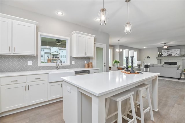 6102 Lewis Dr, Shawnee, KS 66226 - kitchen featuring ceiling fan, white cabinets, light wood-style flooring, light countertops, and recessed lighting