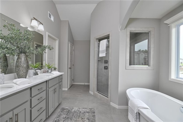 6102 Lewis Dr, Shawnee, KS 66226 - full bath with double vanity, a freestanding tub, and a shower stall