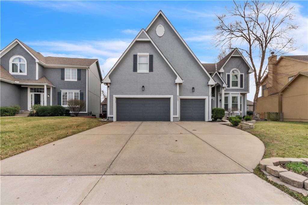 8007 W 131st Ter, Overland Park, KS 66213 - traditional home featuring an attached garage, concrete driveway, a front lawn, and stucco siding