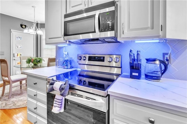 8007 W 131st Ter, Overland Park, KS 66213 - kitchen with stainless steel appliances, light wood-type flooring, backsplash, a chandelier, and light stone countertops