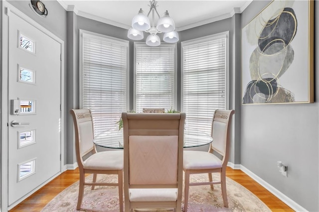 8007 W 131st Ter, Overland Park, KS 66213 - dining room with a chandelier, crown molding, and wood finished floors