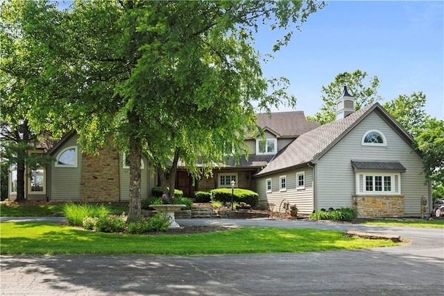 12635 W 183rd St, Overland Park, KS 66013 - view of property hidden behind natural elements with stone siding and a front lawn