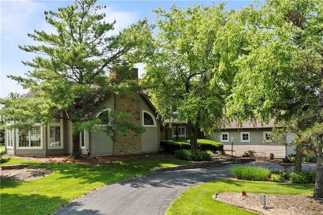 12635 W 183rd St, Overland Park, KS 66013 - view of front of house with a front yard, asphalt driveway, and a chimney