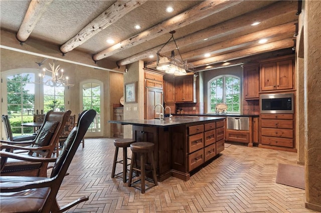 12635 W 183rd St, Overland Park, KS 66013 - kitchen with built in appliances, dark countertops, a breakfast bar area, recessed lighting, and a chandelier