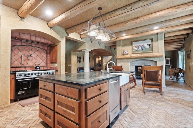 12635 W 183rd St, Overland Park, KS 66013 - kitchen with appliances with stainless steel finishes, decorative columns, dark countertops, brown cabinets, and beam ceiling