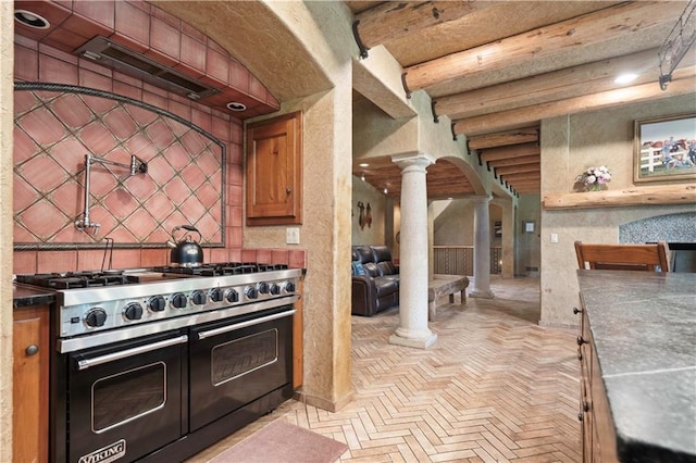12635 W 183rd St, Overland Park, KS 66013 - kitchen featuring decorative columns, range with two ovens, arched walkways, brick patterned floors, and brown cabinets