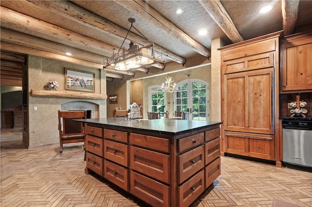 12635 W 183rd St, Overland Park, KS 66013 - kitchen with dark countertops, a fireplace, brown cabinetry, an island with sink, and a chandelier