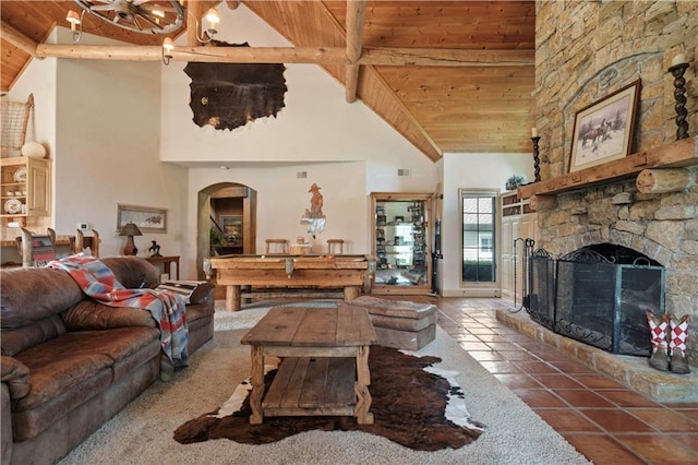 12635 W 183rd St, Overland Park, KS 66013 - tiled living area featuring a wood ceiling with exposed beams, high vaulted ceiling, arched walkways, and a stone fireplace
