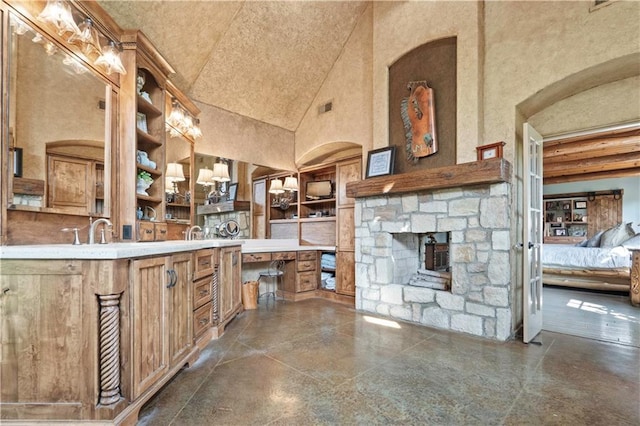 12635 W 183rd St, Overland Park, KS 66013 - bathroom with high vaulted ceiling, a stone fireplace, connected bathroom, and vanity