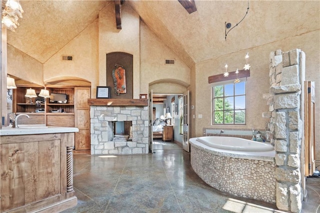 12635 W 183rd St, Overland Park, KS 66013 - full bathroom featuring high vaulted ceiling, a garden tub, vanity, a fireplace, and beam ceiling