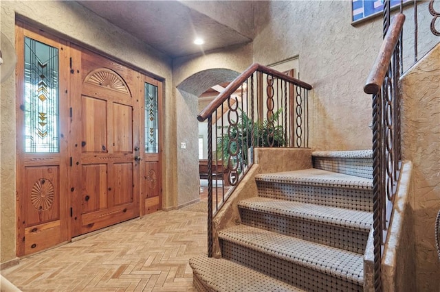 12635 W 183rd St, Overland Park, KS 66013 - entryway featuring a textured wall, stairs, and arched walkways