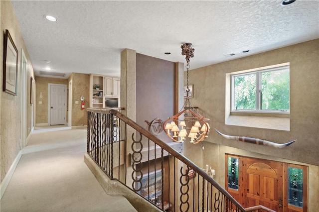 12635 W 183rd St, Overland Park, KS 66013 - corridor with an upstairs landing, a chandelier, a textured ceiling, carpet floors, and recessed lighting