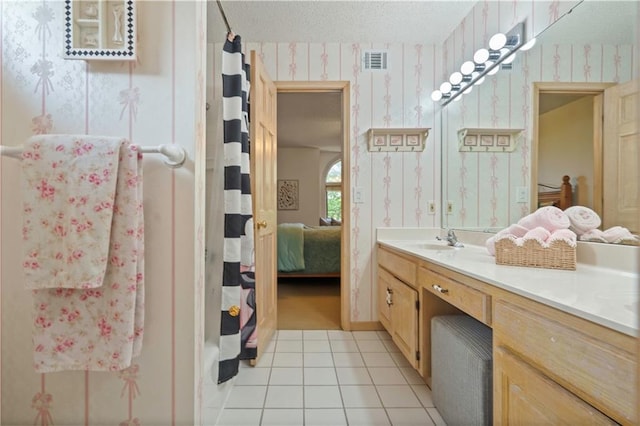 12635 W 183rd St, Overland Park, KS 66013 - ensuite bathroom with wallpapered walls, vanity, a textured ceiling, and tile patterned floors