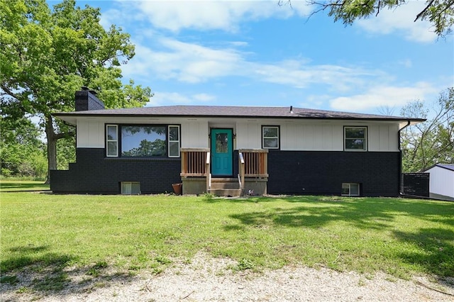 39103 New Lancaster Rd, Lacygne, KS 66040 - single story home featuring brick siding, a chimney, a front lawn, and board and batten siding