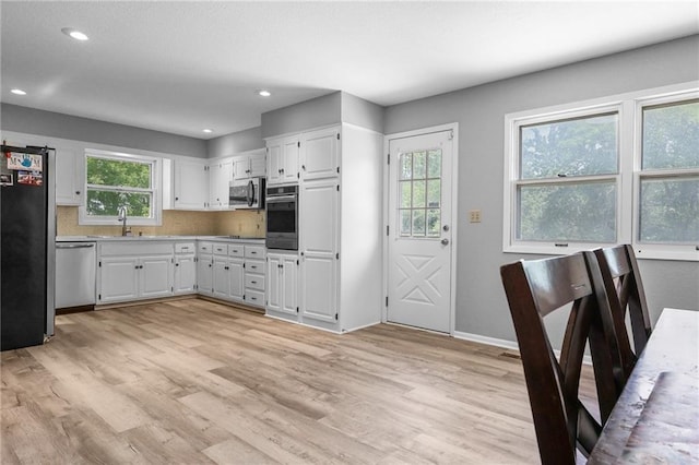 39103 New Lancaster Rd, Lacygne, KS 66040 - kitchen featuring stainless steel appliances, light wood-type flooring, white cabinetry, recessed lighting, and light countertops
