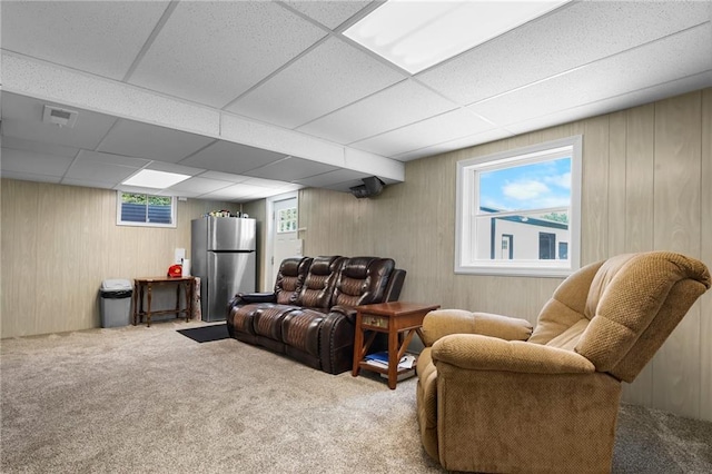 39103 New Lancaster Rd, Lacygne, KS 66040 - living room with carpet floors, wooden walls, and a paneled ceiling