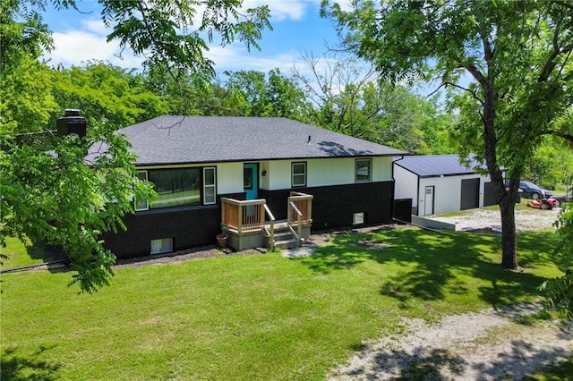 39103 New Lancaster Rd, Lacygne, KS 66040 - rear view of property featuring a yard, a chimney, a detached garage, roof with shingles, and an outbuilding