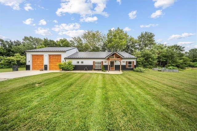 6401 SE Hamilton Rd, Holt, MO 64048 - view of front of property with a front lawn, driveway, a metal roof, and an attached garage