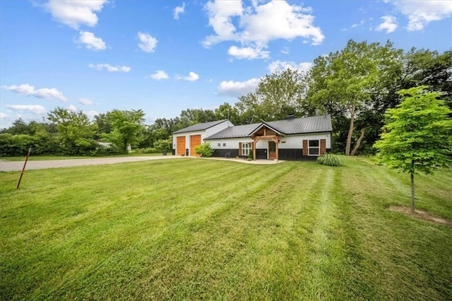 6401 SE Hamilton Rd, Holt, MO 64048 - single story home with driveway, a front lawn, a metal roof, and an attached garage