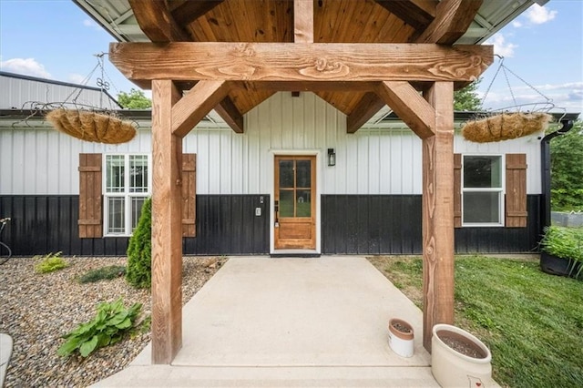 6401 SE Hamilton Rd, Holt, MO 64048 - property entrance featuring a patio and board and batten siding