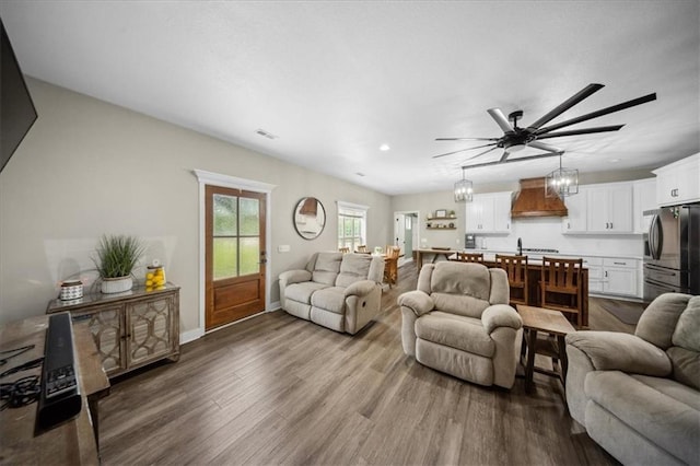 6401 SE Hamilton Rd, Holt, MO 64048 - living area with ceiling fan, dark wood-type flooring, a chandelier, and recessed lighting