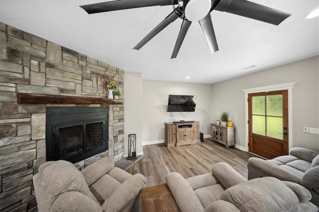 6401 SE Hamilton Rd, Holt, MO 64048 - living area featuring a stone fireplace, wood finished floors, recessed lighting, and a ceiling fan