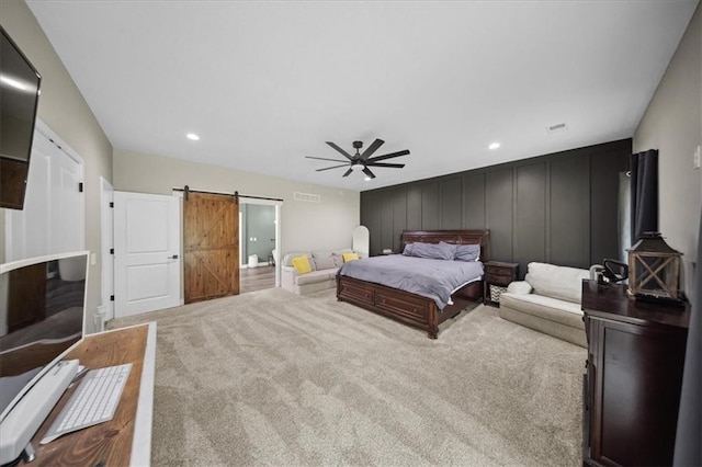 6401 SE Hamilton Rd, Holt, MO 64048 - carpeted bedroom featuring a barn door, a decorative wall, a ceiling fan, and recessed lighting