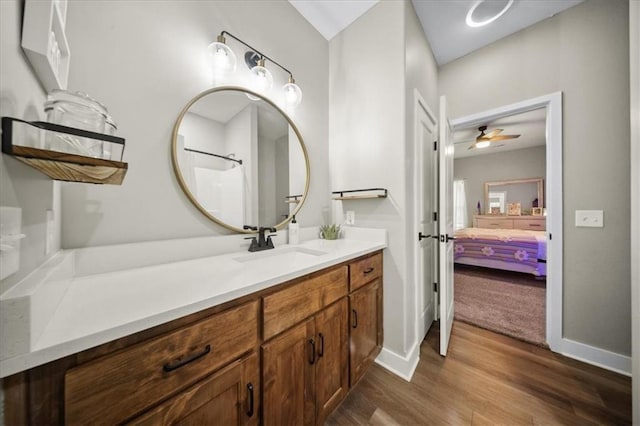 6401 SE Hamilton Rd, Holt, MO 64048 - bathroom with vanity, wood finished floors, a ceiling fan, and ensuite bath