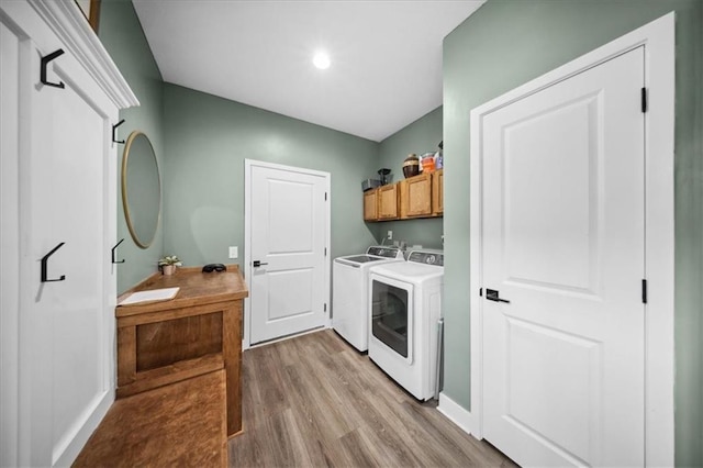 6401 SE Hamilton Rd, Holt, MO 64048 - washroom featuring cabinet space, washing machine and clothes dryer, light wood-style floors, and recessed lighting