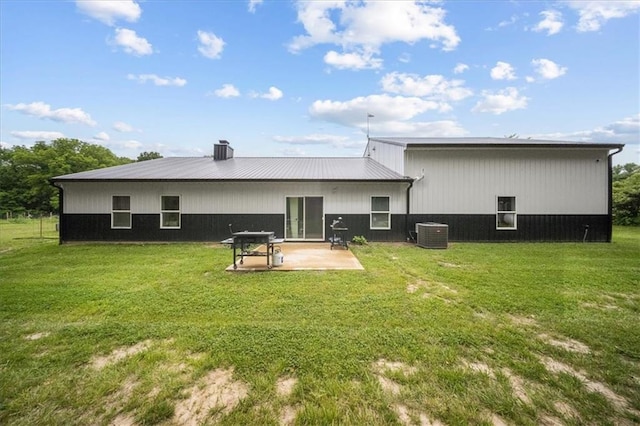 6401 SE Hamilton Rd, Holt, MO 64048 - back of house featuring a lawn, a patio, a chimney, and a metal roof