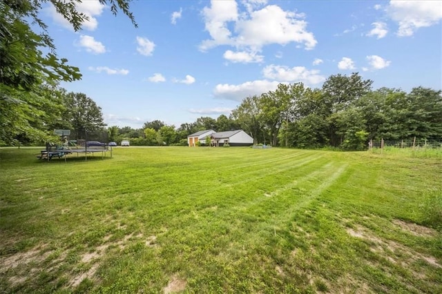 6401 SE Hamilton Rd, Holt, MO 64048 - view of green lawn with a trampoline